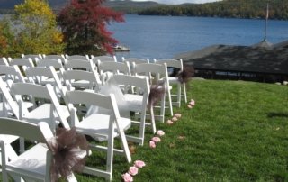 Grassy area overlooking lake setup for a wedding ceremony.