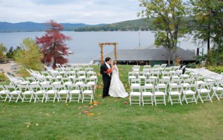 Wedding couple kissing near lake.