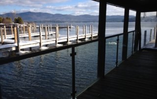 Area near water of Boathouse Restaurant showing off new glass panels.