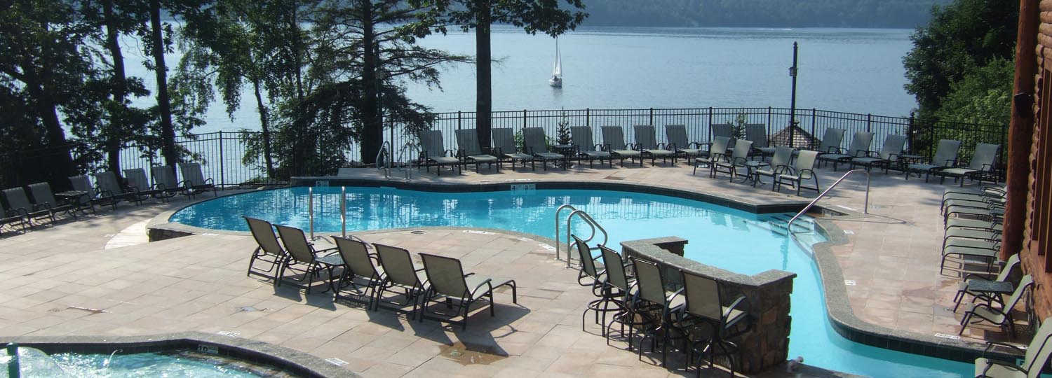 Outdoor pool area near lake.