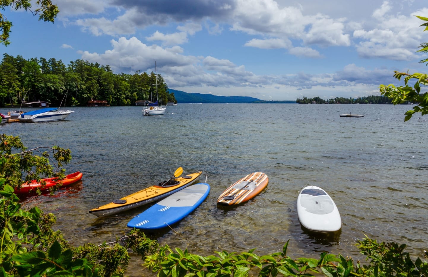 Kayaks sitting near shore of Lake George.