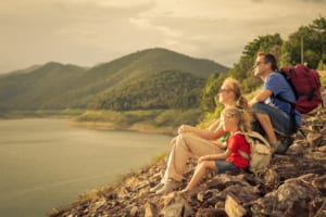 Photo of a Small Family Looking at the Mountains