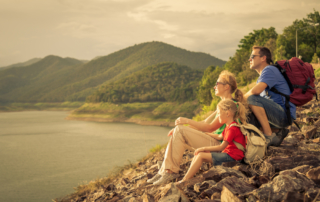 Photo of a Small Family Looking at the Mountains