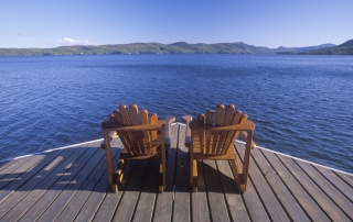 A pair of Adirondack chairs overlooking pristine Lake George.