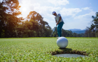 Photo of a Man Putting at a Lake George Golf Course.