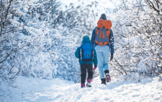 Photo of parent and child enjoying a winter walk, a great Lake George winter activity