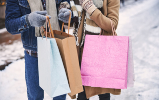Photo of two people shopping bags after browsing Lake George shops