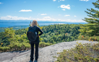 Person overlooking mountains and lake on one of the best Adirondack hikes