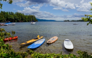 View of Lake George and watersport equipment in front of Lodges at Cresthaven